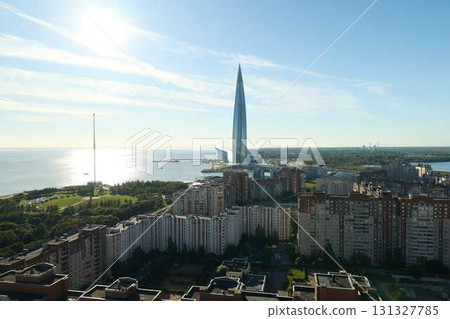A stunning cityscape featuring a magnificent modern skyscraper alongside a beautiful seaside view A stunning cityscape featuring a magnificent modern skyscraper alongside a beautiful seaside view 131327785