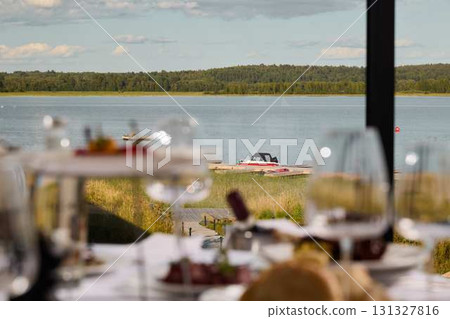 Enjoy Elegant Dining with Breathtaking Views of Serene Waters and the Scenic Landscape Enjoy Elegant Dining with Breathtaking Views of Serene Waters and the Scenic Landscape 131327816