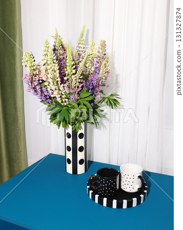 A Vibrant and Eyecatching Floral Arrangement Featuring a Stylish Black and White Vase A Vibrant and Eyecatching Floral Arrangement Featuring a Stylish Black and White Vase 131327874