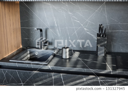 This modern kitchen sink has stylish accessories that beautifully complement a textured countertop This modern kitchen sink has stylish accessories that beautifully complement a textured countertop 131327945