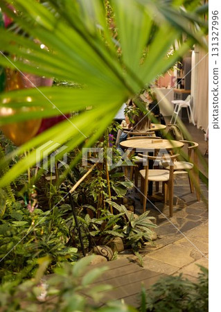 A Cozy Garden Dining Space That is Surrounded by Beautifully Lush Greenery and Plants 131327996