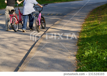 Bicycle Riders Relishing a Beautiful, Sunny Day on a Scenic, Picturesque Pathway Bicycle Riders Relishing a Beautiful, Sunny Day on a Scenic, Picturesque Pathway 131328103
