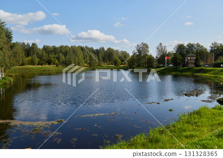 A Beautiful and Serene Lake Surrounded by Lush Greenery Under a Stunning Blue Sky Above A Beautiful and Serene Lake Surrounded by Lush Greenery Under a Stunning Blue Sky Above 131328365
