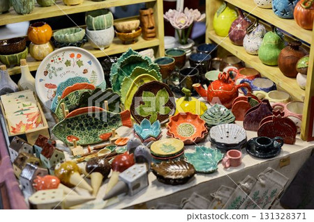 Explore the colorful and vibrant handcrafted pottery collection available at the Artisan Market 131328371