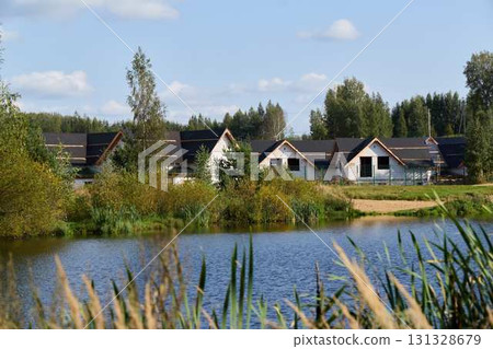 Tranquil Lakeside Homes, Tranquility Surrounded by Lush Nature in the Vibrant Summer Season Tranquil Lakeside Homes, Tranquility Surrounded by Lush Nature in the Vibrant Summer Season 131328679