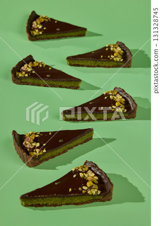 Indulgent and Decadent Chocolate and Pistachio Tart Slices for your sweet tooth pleasure 131328745