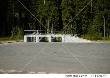 A Concrete Ramp is Discovered Nestled Within a Vibrant and Thriving Forest in Natures Warm Embrace A Concrete Ramp is Discovered Nestled Within a Vibrant and Thriving Forest in Natures Warm Embrace 131328933