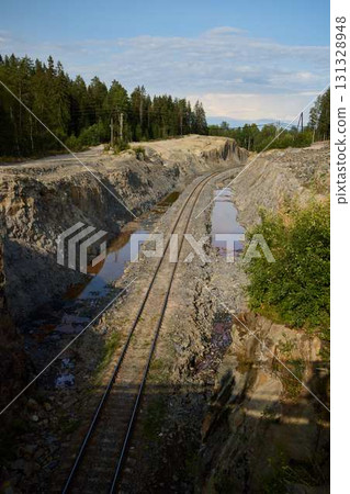 Railway Tracks Surrounded by an Abandoned Quarry Landscape Showing Nature and Serenity Railway Tracks Surrounded by an Abandoned Quarry Landscape Showing Nature and Serenity 131328948