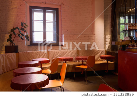 The interior of the cozy cafe features bright colors complemented by plenty of natural light 131328989