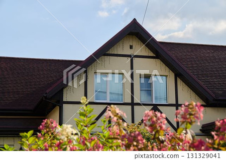 Charming House with a Beautiful Flowering Garden, Showcasing Natures Aesthetic Appeal Charming House with a Beautiful Flowering Garden, Showcasing Natures Aesthetic Appeal 131329041
