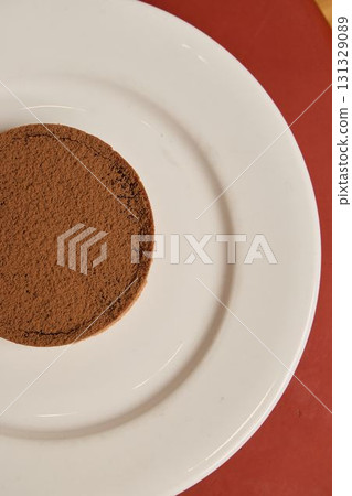 A Deliciously Decadent Chocolate Cake Beautifully Presented on an Elegant White Plate A Deliciously Decadent Chocolate Cake Beautifully Presented on an Elegant White Plate 131329089