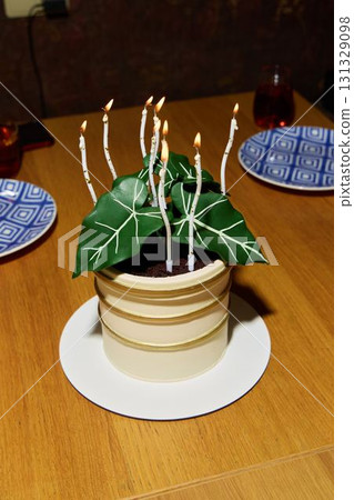 A Whimsical Cake Creatively Designed to Look Like a Potted Plant Completed with Candles 131329098