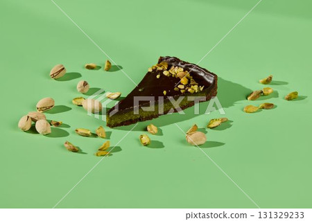 This is a Delicious Chocolate Pistachio Dessert Presented on a Striking Green Background 131329233