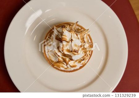 A Delicious and EyeCatching Meringue Tart Gracefully Presented on an Elegant Plate A Delicious and EyeCatching Meringue Tart Gracefully Presented on an Elegant Plate 131329239