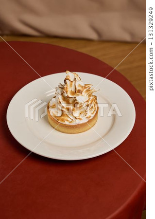 A Delicious Meringue Topped Tart That Is Beautifully Presented on an Elegant Plate for Enjoyment A Delicious Meringue Topped Tart That Is Beautifully Presented on an Elegant Plate for Enjoyment 131329249