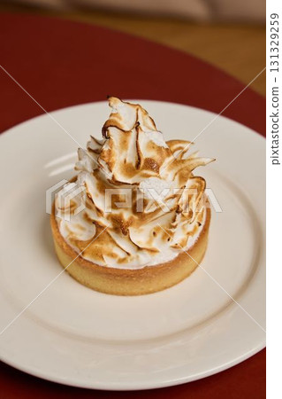 Enjoy a delicious meringue tart with a glorious golden sweet topping that delights 131329259