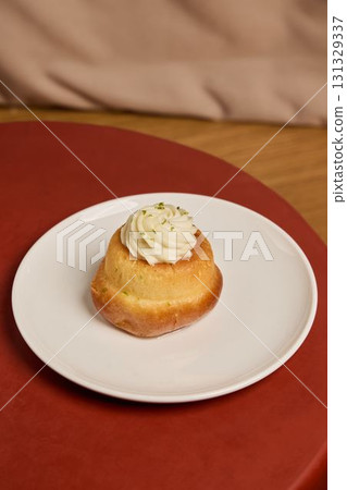 A Delicious and CreamTopped Dessert Beautifully Presented on a Plate for All to Enjoy 131329337