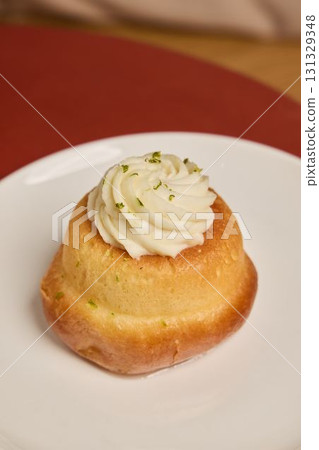 A delightful Mini Cake with creamy frosting and colorful sprinkles, perfect for any occasion 131329348