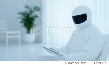 Futuristic humanoid robot in a minimalist environment, engaged with a tablet while 131329354