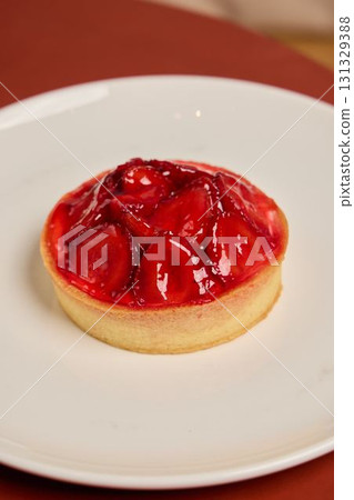 A mouthwatering and delicious Strawberry Tart beautifully presented on a pristine white plate A mouthwatering and delicious Strawberry Tart beautifully presented on a pristine white plate 131329388