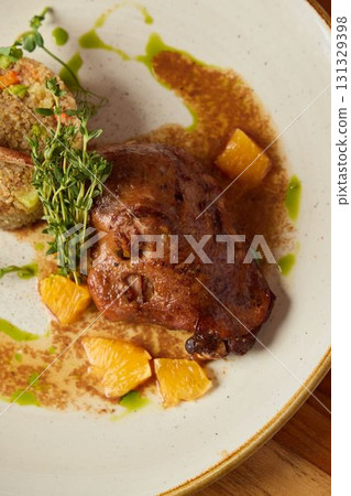 Gourmet Display of Succulent, Savory Meat Accompanied by Citrus Fruits and Aromatic Herbs 131329398