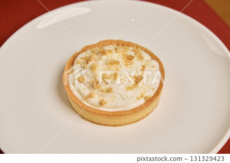 Indulgent and Delicious Creamy Dessert Tart with a Delectable Crumbled Topping on Top Indulgent and Delicious Creamy Dessert Tart with a Delectable Crumbled Topping on Top 131329423
