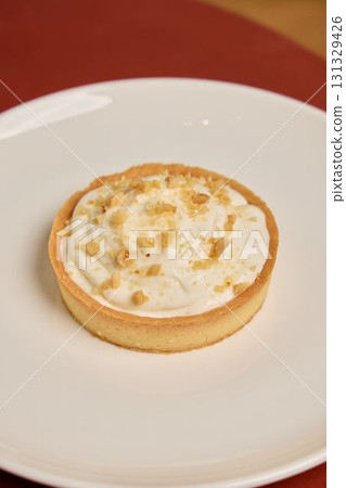 Indulge in a Deliciously Creamy Dessert Tart that comes topped with Nutty Goodness Indulge in a Deliciously Creamy Dessert Tart that comes topped with Nutty Goodness 131329426