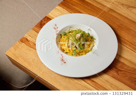 An Elegant and Beautiful Plate of a Gourmet Rice Dish prepared with Fresh and Flavorful Ingredients An Elegant and Beautiful Plate of a Gourmet Rice Dish prepared with Fresh and Flavorful Ingredients 131329431