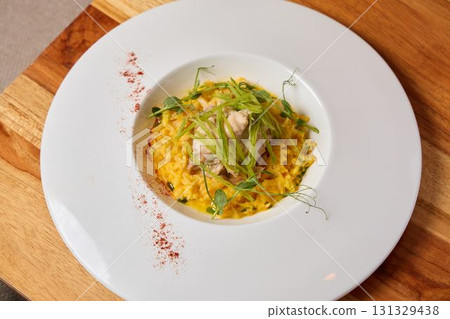 Indulge in a Delicious Gourmet Risotto complemented with Fresh Herbs and Tender Chicken 131329438