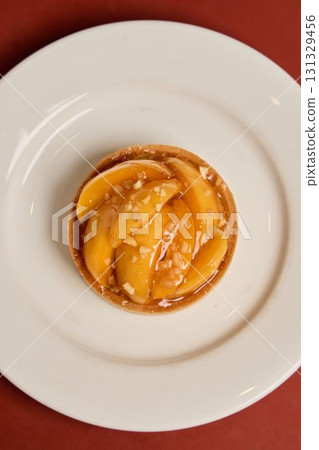A Delicious Peach Tart with a Rich Caramel Glaze Served on a Beautiful White Plate A Delicious Peach Tart with a Rich Caramel Glaze Served on a Beautiful White Plate 131329456