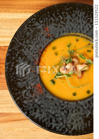 A truly Delicious Gourmet Soup served elegantly in a classy Black Bowl perfect for dining A truly Delicious Gourmet Soup served elegantly in a classy Black Bowl perfect for dining 131329522
