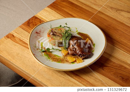 An exquisite gourmet dish featuring succulent meat combined with colorful accompaniments An exquisite gourmet dish featuring succulent meat combined with colorful accompaniments 131329672