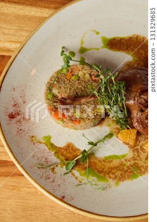 A Gourmet Dish featuring Colorful Fresh Vegetables accompanied by a sauce served on an Elegant Plate 131329685