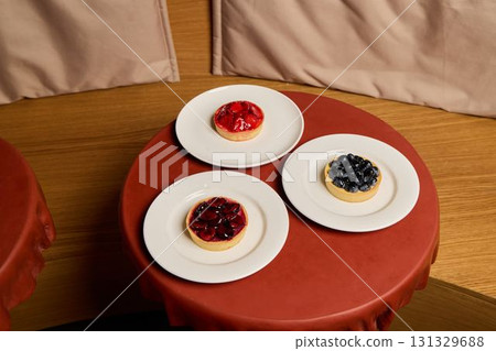 Indulge in Delicious Fruit Tarts Beautifully Presented on Elegant Plates with Style Indulge in Delicious Fruit Tarts Beautifully Presented on Elegant Plates with Style 131329688