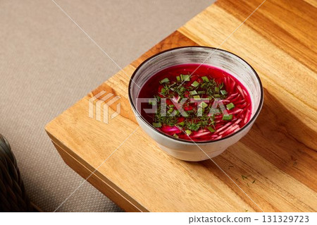 Deliciously Vibrant Beetroot Soup Garnished with Fresh Herbs for a Colorful Presentation 131329723