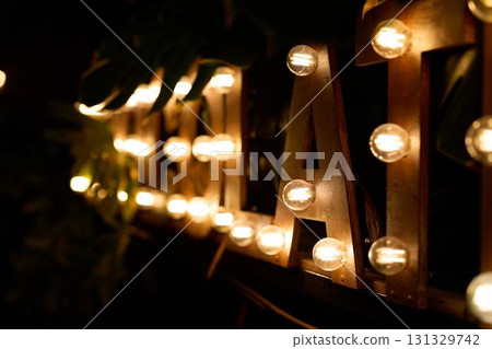 A Beautifully Illuminated Vintage Sign Featuring Warm, Inviting Lights Set Against the Night Sky A Beautifully Illuminated Vintage Sign Featuring Warm, Inviting Lights Set Against the Night Sky 131329742