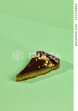 Indulge in a Delicious Slice of Chocolate Pistachio Cake Against a Vibrant Colorful Background Indulge in a Delicious Slice of Chocolate Pistachio Cake Against a Vibrant Colorful Background 131329869