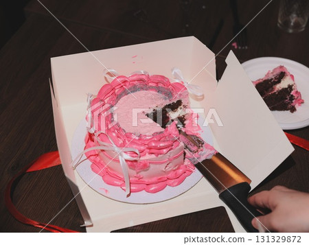 A Delicious and Beautifully Layered Cake with Pink Frosting Perfect for a Celebration Event 131329872