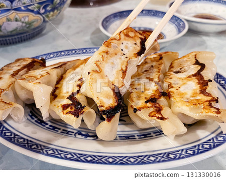 Pan-fried dumplings: A Chinese dish with a crispy, fragrant skin. Pan-fried dumplings: A Chinese dish with a crispy, fragrant skin. 131330016