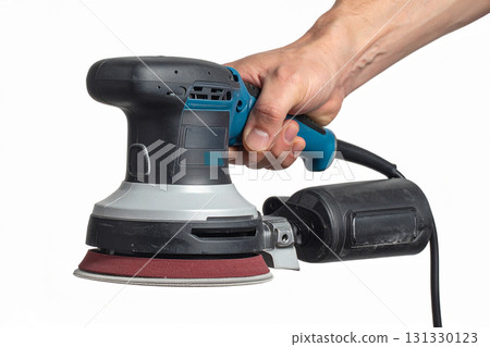 an orbital sander in a man's hand an orbital sander in a man's hand 131330123