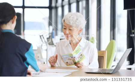 Elderly Asian people receiving explanation about nursing care facilities 131331735