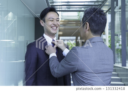 A man fixing his subordinate's tie in the office. Photo courtesy of Sky Perfect Tokyo Media Center A man fixing his subordinate's tie in the office. Photo courtesy of Sky Perfect Tokyo Media Center 131332418