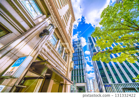 Tokyo cityscape in Japan: Kyobashi office district. View of the Meijiya Kyobashi Building and the Kyobashi Station entrance. Tokyo cityscape in Japan: Kyobashi office district. View of the Meijiya Kyobashi Building and the Kyobashi Station entrance. 131332422