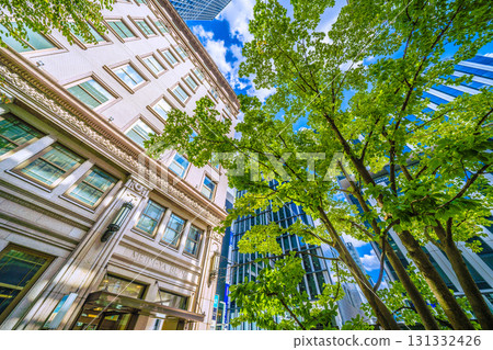 Tokyo cityscape in Japan: Kyobashi office district. View of the Meijiya Kyobashi Building and the Kyobashi Station entrance. 131332426