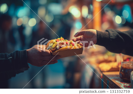 Busy street vendor hands off delicious tacos in a vibrant night market scene 131332759