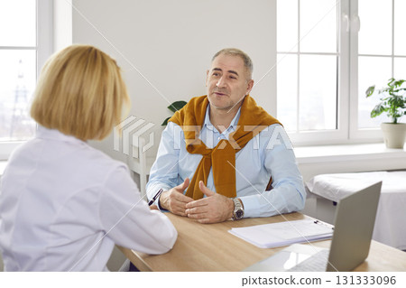 Mature male patient getting professional medical consultation from doctor at clinic 131333096