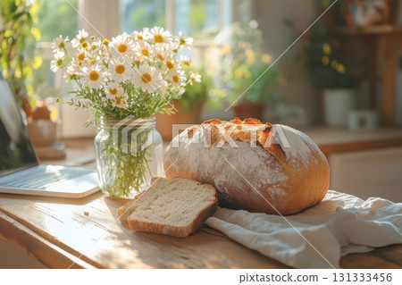 Rustic bread loaf with daisies in sunlight Rustic bread loaf with daisies in sunlight 131333456