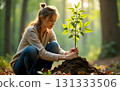 woman planting a tree, weeding and digging in the garden for environment 131333506