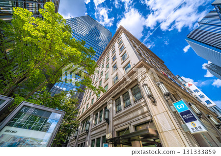 Tokyo cityscape in Japan: Kyobashi office district. View of the Meijiya Kyobashi Building and the Kyobashi Station entrance. Tokyo cityscape in Japan: Kyobashi office district. View of the Meijiya Kyobashi Building and the Kyobashi Station entrance. 131333859