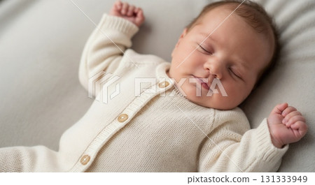 A newborn baby peacefully sleeping in white clothes. A newborn baby peacefully sleeping in white clothes. 131333949